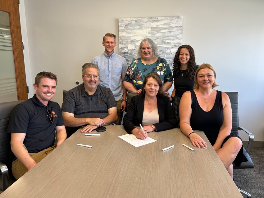 The Golden Hills Mobile Home Park co-op board members, front row, celebrate signing the final papers to purchase their park July 11. In the back row, representatives from nonprofits Golden United and Thistle support the purchase. The co-op purchased Golden Hills for $8.5 million thanks to support from nonprofit and government partners, including Jefferson County and the City of Golden.